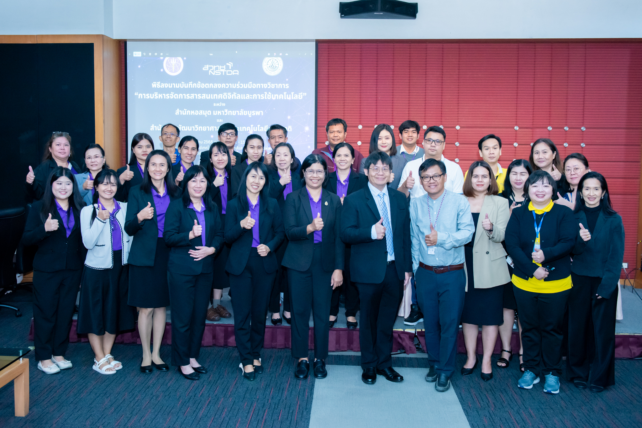 ภาพบรรยากาศ ผู้บริหารและบุคลากรของทั้งสองหน่วยงาน ถ่ายภาพหมู่ร่วมกัน ด้านหน้าเวที