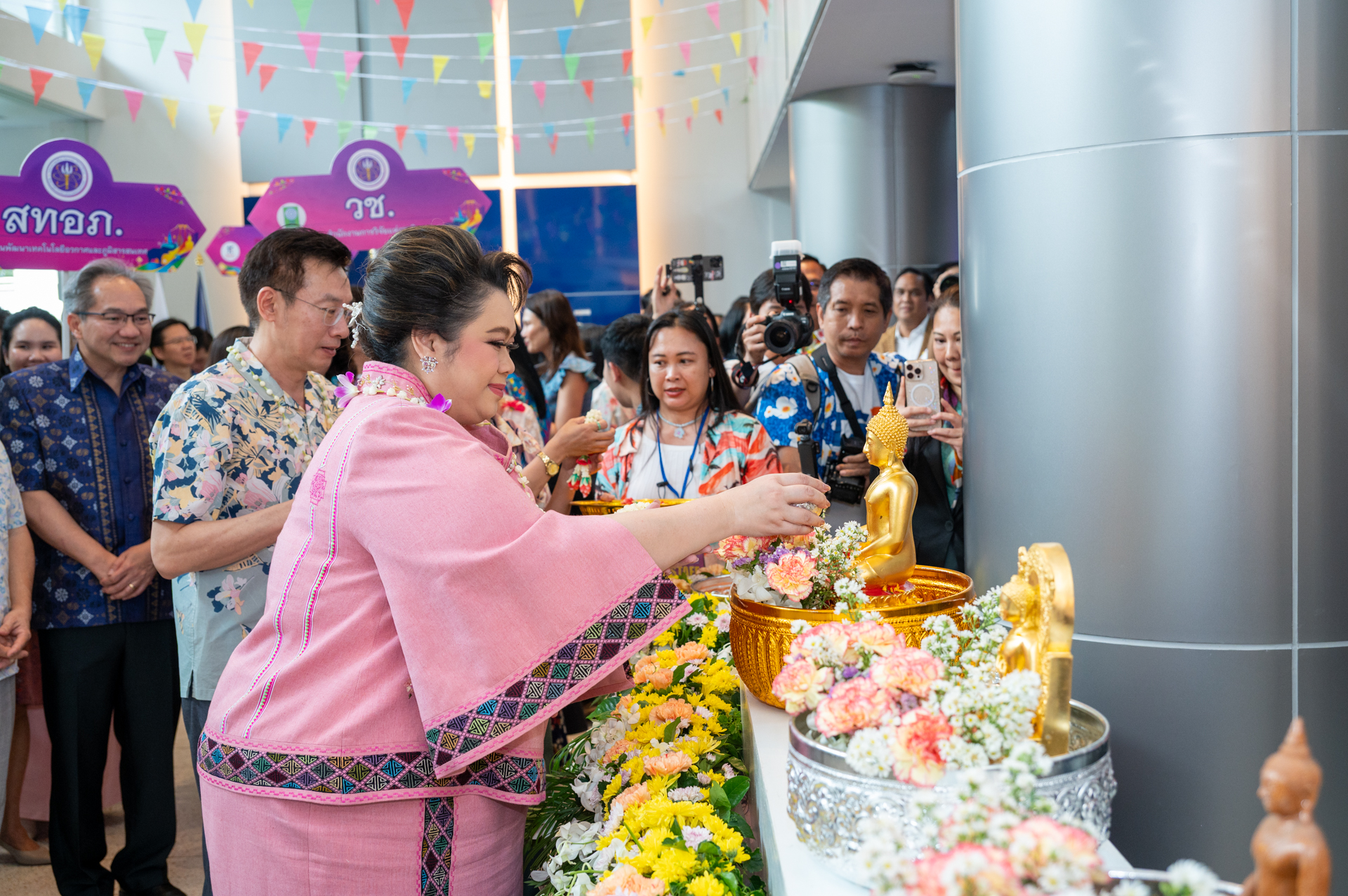 ภาพ นางสาวศุภมาส อิศรภักดี รัฐมนตรีว่าการกระทรวง อว. ร่วมสรงน้ำพระพุทธรูป ในงาน และมีผู้บริหารหน่วยงานต่าง ภายใต้ อว. ยืนร่วมพิธี