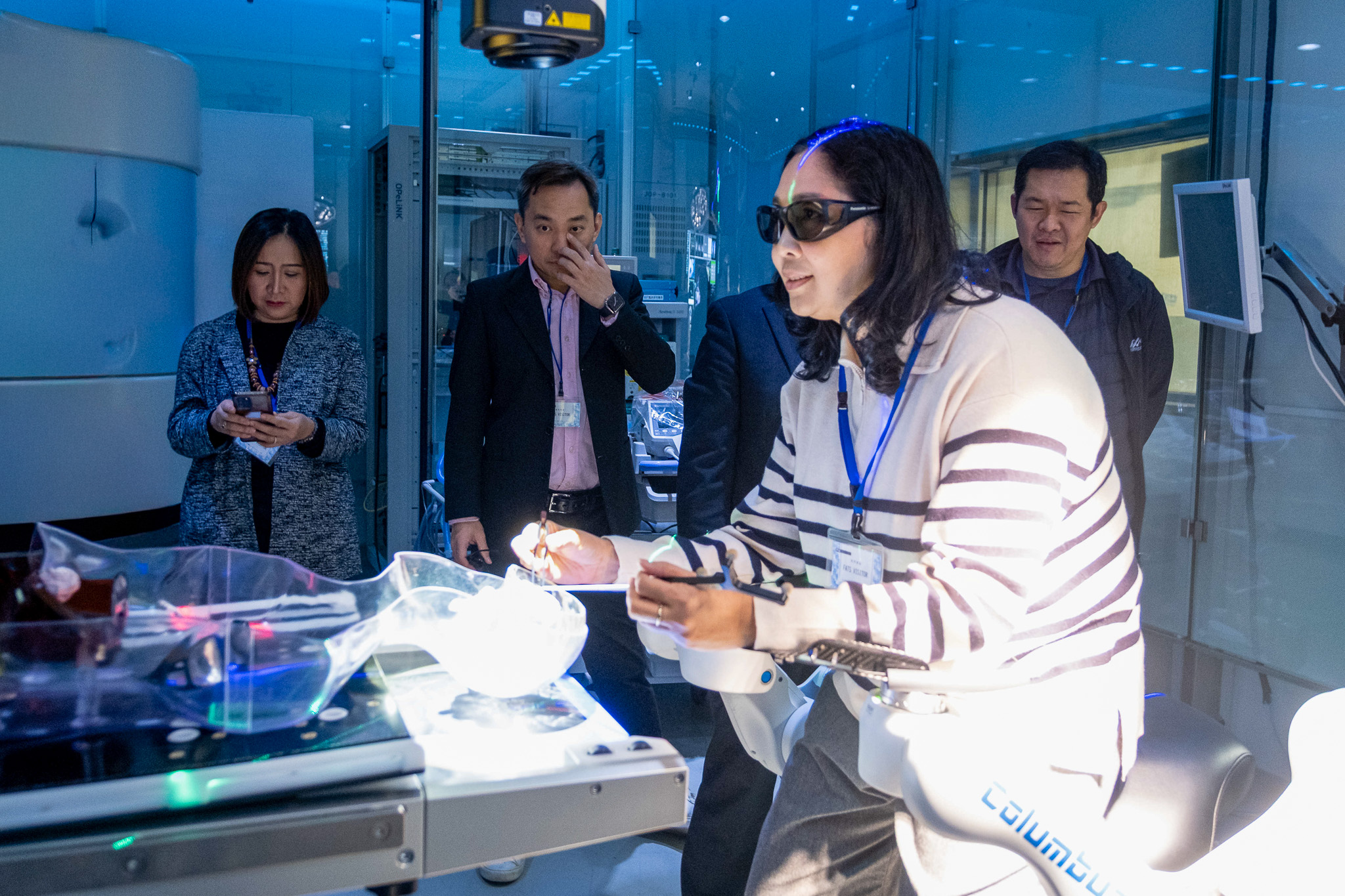 ภาพคณะผู้แทน สวทช. สวมอุปกรณ์จำลองการผ่าตัดแบบภาพเสมือนจริงภายในห้องปฏิบัติการ TWMU