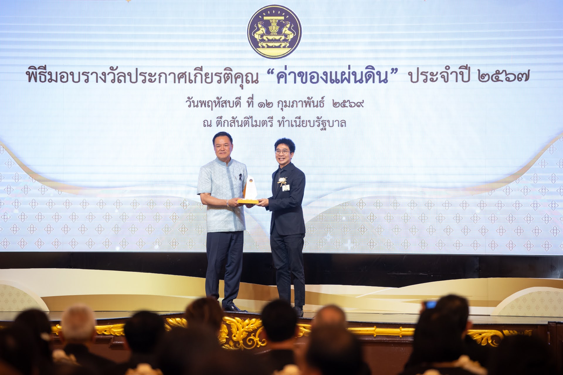 ภาพดร.วสันต์ ภัททรอธิคม ผู้ช่วยผู้อำนวยการ สวทช. ขึ้นรับมอบรางวัลโล่ประกาศเกียรติคุณ ด้านการพัฒนาสังคมและส่งเสริมคุณภาพชีวิต จากนายอนุทิน ชาญวีรกูล นายกรัฐมนตรี ประเภทโครงการ จากผลงานการพัฒนา Traffy Fondue แพลตฟอร์มบริหารจัดการปัญหาเมือง